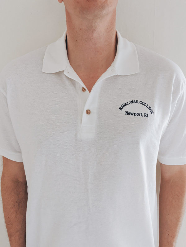 White men's polo shirt with Naval War College written on the left